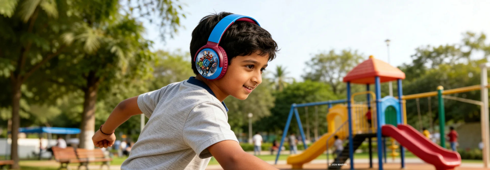 Boy using Marvel Avengers Bluetooth headphones with swivel cups while playing outdoors, wireless headphones for kids active lifestyle